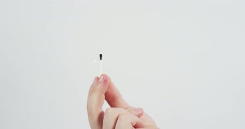 Burning Match Close Up on White Background
