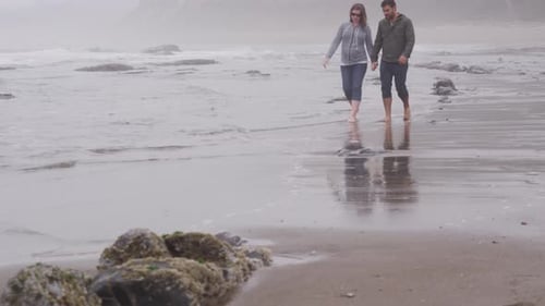 Couple walking at beach together. Shot on RED EPIC for high quality 4K, UHD, Ultra HD resolution.