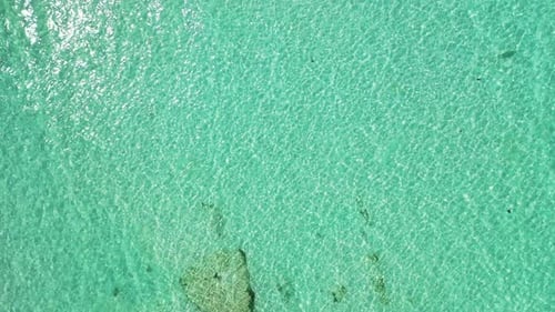 Daytime flying abstract view of a white paradise beach and aqua blue water background