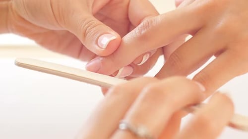 Manicurist Filing Nails with Wooden File