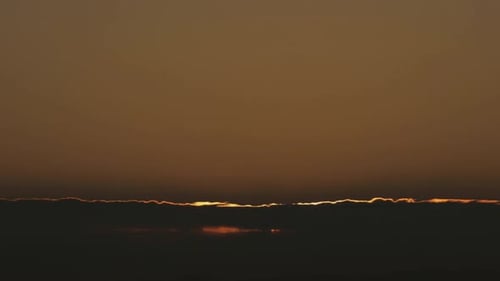 Majestic Sunrise over a Bed of Clouds