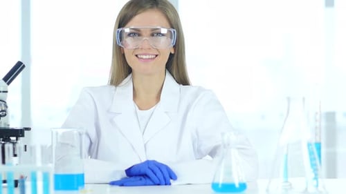 Smiling Scientist with Goggles in Modern Lab