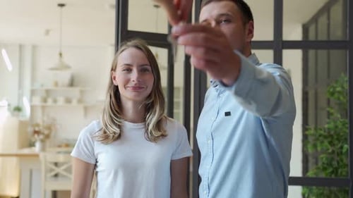 Happy Couple Receiving Apartment Key From Real Estate Agent. Happy Couple Smiling and Getting Keys