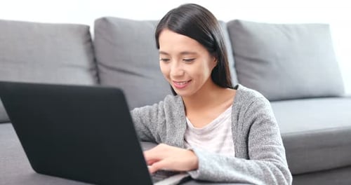 Young Woman Works on Laptop at Home