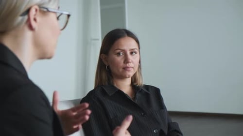 Professional Women Talking in Office Meeting
