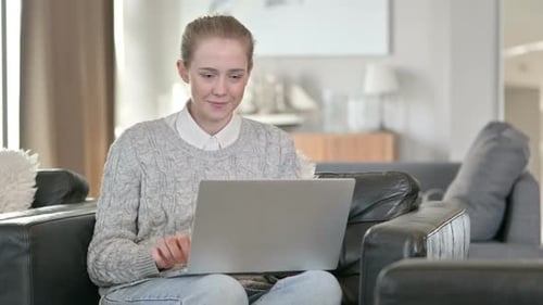 Woman Using Laptop is Happy and Excited