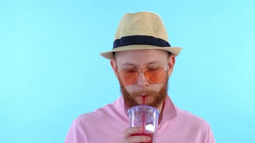 Man Drinks Refreshing Beverage with Straw