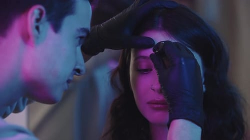 Beautician plucking eyebrows in beauty salon