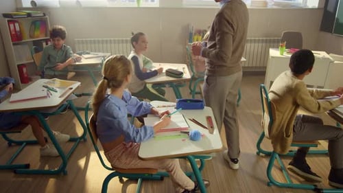 Children Learning in Elementary School Classroom with Teacher