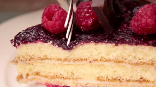 Cutting Into Delicious Berry and Chocolate Cake