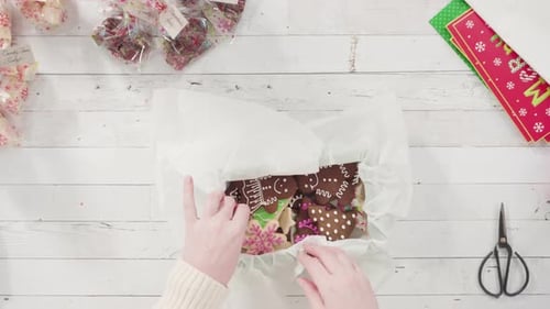 Time lapse. Flat lay. Step by step. Packaging homemade fudge and cookies into a Christmas gift box