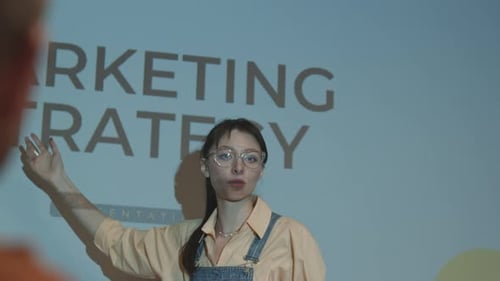 Young Woman Presents Marketing Strategy to Audience