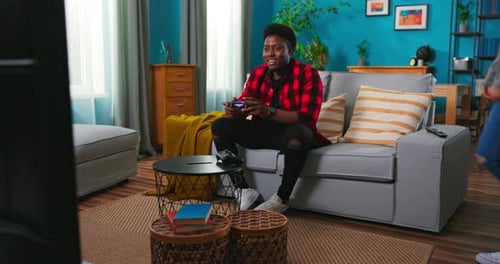 Friends Playing Video Games in Living Room