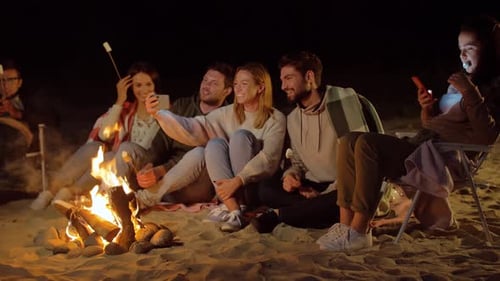 Happy Friends Taking Selfie at Camp Fire on Beach