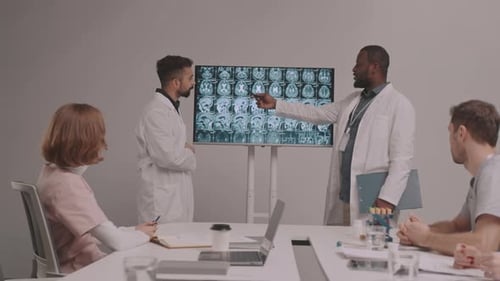 Medical Professionals Reviewing Brain Scans in Meeting