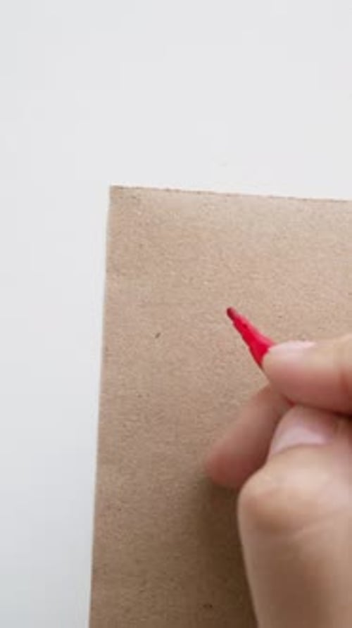 Writing Number Five on Cardboard with Red Marker