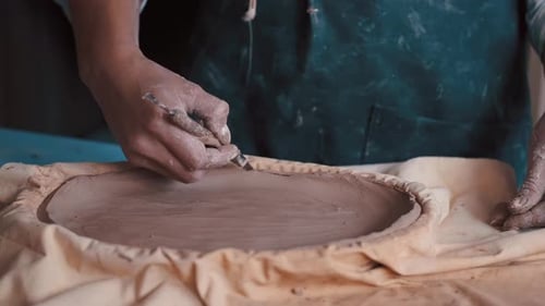 Hands Shaping Clay in Studio