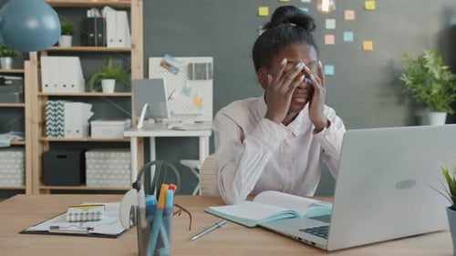 Woman Working at Desk with Computer and Paper