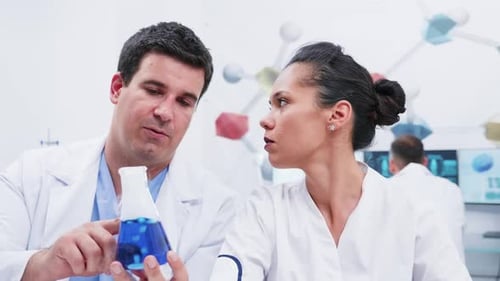 Scientists Discussing Experiment in Bright Modern Laboratory