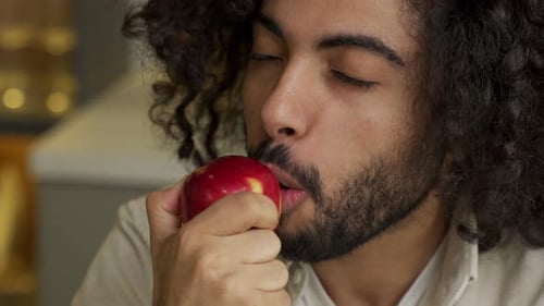 Man Eating Red Apple Close-Up
