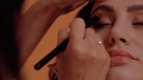Applying eyeshadow for a glamorous look, close up