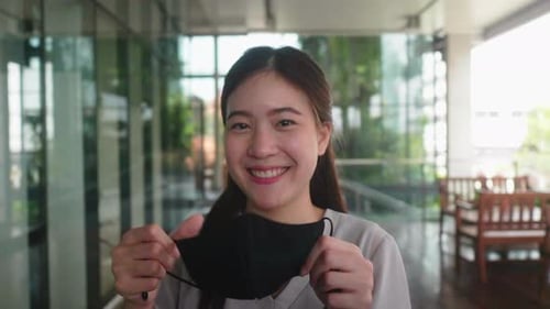 young woman person taking off a mask, surgical face mask take off
