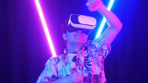 Vr, Futuristic, Excited Asian Man Using Virtual Reality Headset And Funny Dance With Neon Light