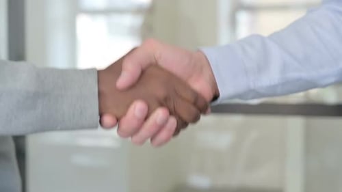 Close Up of Mixed Race Businessmen Shaking Hands in Slow Motion