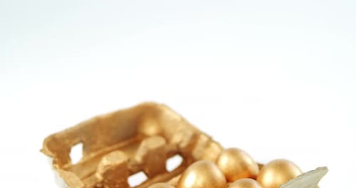 Close-up of golden Easter eggs in the tray