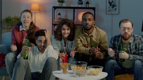 Portrait of Young Men and Women Watching Sports on TV Holding Drinks Feeling Unhappy at Home at