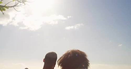 Couple sitting together on a bench in the beach 4k