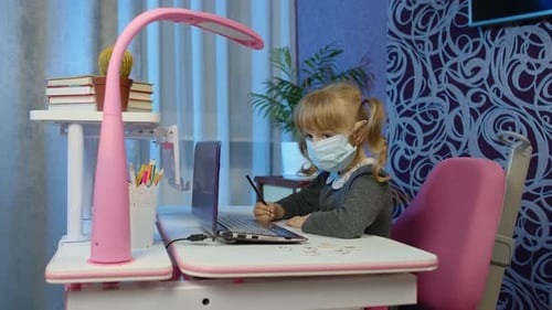 Little Girl Studying at Desk with Computer