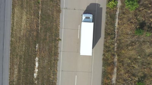 Aerial View of Truck with Trailer Driving on Straight Road and Transporting Goods