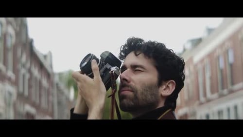 Man taking pictures of a building in the city