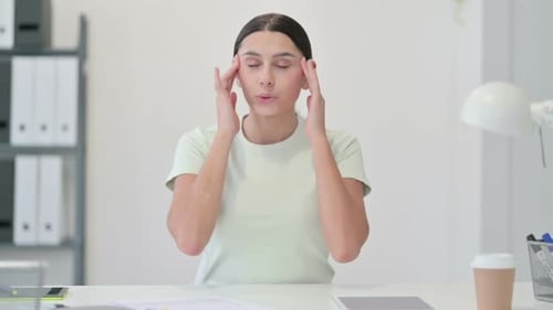 Tired Young Latin Woman Having Headache in Office