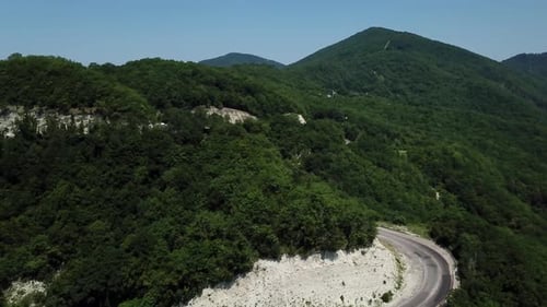 Aerial View From Above of Curve Road with a Car on the Mountain with Green Forest in Russia