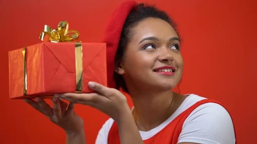 Smiling Woman Holding Wrapped Birthday Gift Close Up
