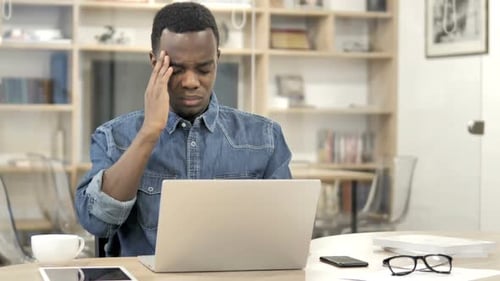 Young Adult Suffering From a Headache at Home