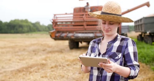 Farmer Using Tablet in Harvested Field