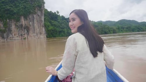 Woman Enjoying Boat Ride Through Tropical Landscape