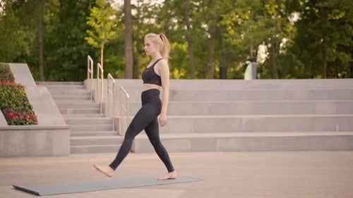 Fitness Woman Practice Yoga Exercises On Mat Outdoor City Street Sunlight Background