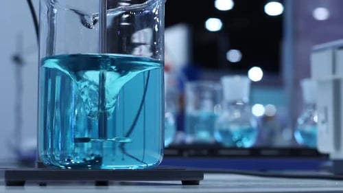 Swirling Turquoise Liquid in Laboratory Beaker