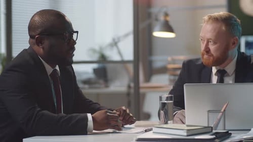 Multiethnic Male Colleagues Discussing Business in Office