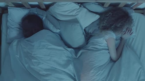 Man Messaging while Wife Sleeping