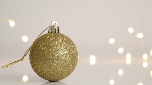 Golden Christmas Ornament with Warm Bokeh Lights
