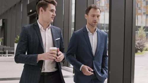 Two Businessmen Going along Office Hall and Chatting