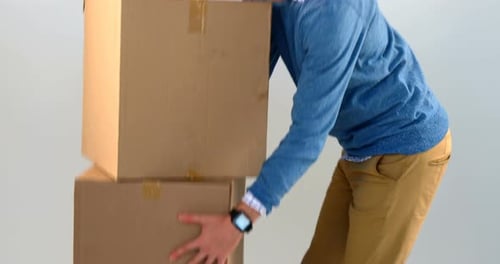 Courier man picking up cardboard boxes
