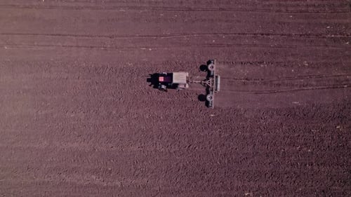 Tractor Tilling Center of Farm Field in the Fall