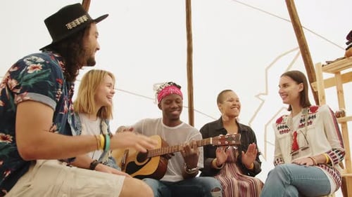 Group of Friends Sing Together in a Teepee
