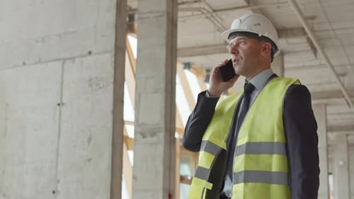 Foreman Talking on Phone in Construction